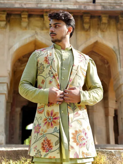 Adjusting the jacket, this shot gives a closer look at the beautiful floral print and the perfect tailoring of this unique Nehru jacket.