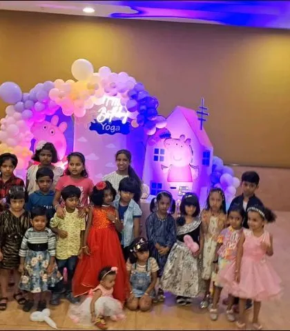 Another great group photo from a Peppa Pig party. The colorful decor provides a cheerful backdrop for capturing the memories of the day.