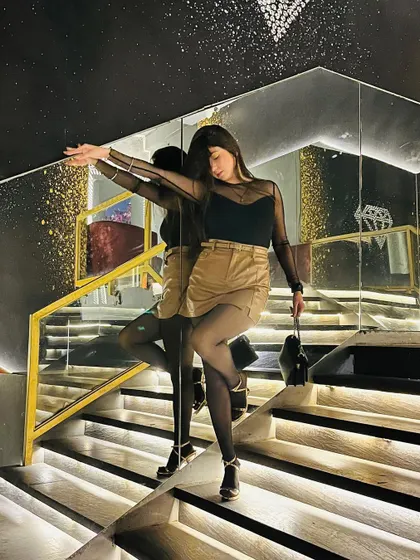 A more artistic pose, using the mirror's reflection to create a cool, layered effect.