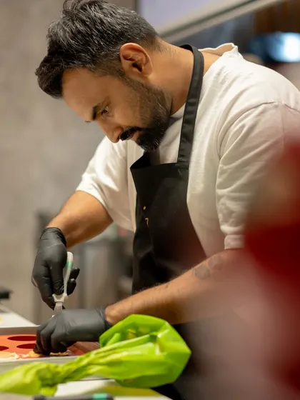 Our chef demonstrates a technique to the class, his focus entirely on the task at hand.