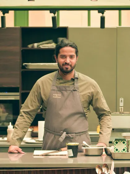 A moment of readiness before service begins. I stand proud in my workspace, ready to create an exceptional meal for my guests.