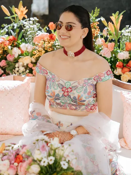 The bride, radiant in the Jaipur sun. The poolside decor for her welcome lunch was filled with pastel florals and traditional elements to create a beautiful, celebratory mood.