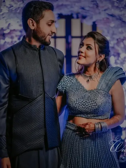 A beautiful shot of the couple at their Sangeet, framed by a stunning floral tunnel, capturing a moment of quiet romance.
