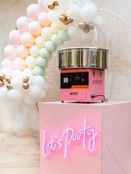 Let's Party! This chic and modern setup with a neon sign shows how our cotton candy station can be styled for a trendy, upscale event.