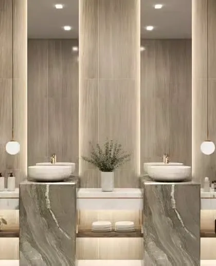 A grand bathroom design featuring dual vanities with marble pedestals and vessel sinks. The wood-textured wall tiles and pendant lights create a symmetrical and spa-like ambiance.