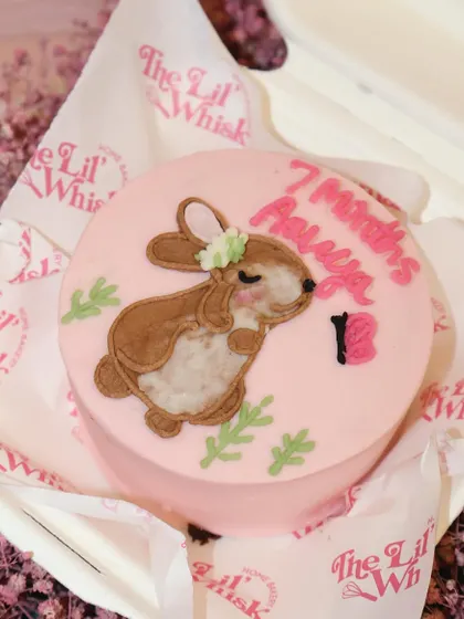 Celebrating a sweet milestone with this adorable bunny-themed bento cake. The hand-piped bunny and soft pink frosting make this a perfect cake for a baby's 7-month celebration or a child's birthday.