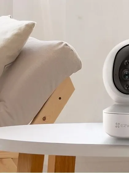 The EZVIZ smart home camera is a popular choice for indoor monitoring. Placed on a table in a living room, its sleek design blends into your home decor while providing features like motion tracking and two-way talk.