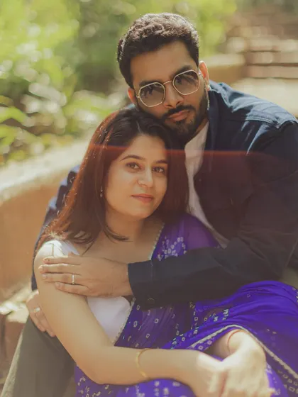 A stylish and intimate portrait of the couple embracing, showcasing their traditional yet modern style.