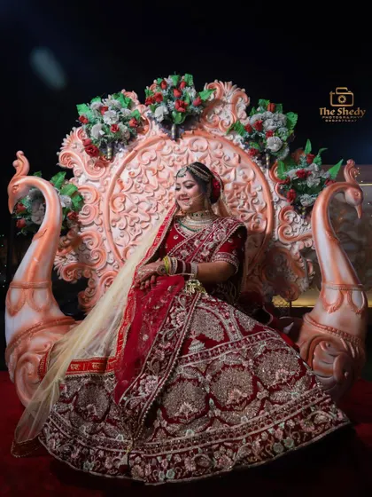 A royal bridal portrait on a swan-themed throne. This grand setup makes for a truly majestic and unforgettable photograph.