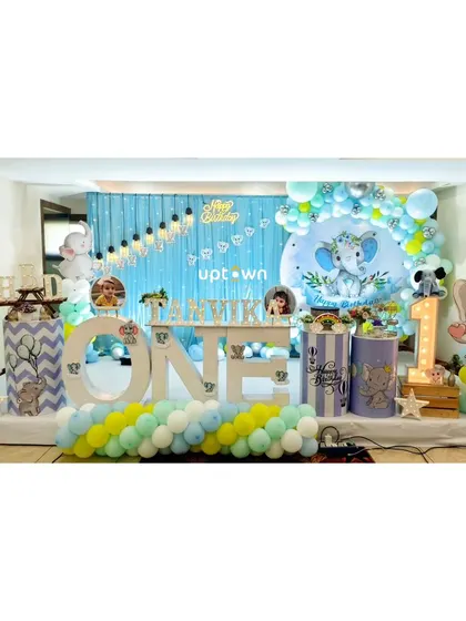 The full stage setup for this personalized baby elephant party.