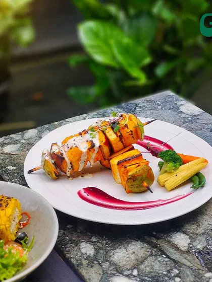 Our cottage cheese skewers are marinated and grilled to perfection, served with a side of fresh salad and corn on the cob.