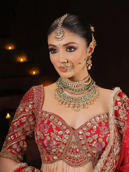 A close-up portrait focusing on the stunning eye makeup. The sharp winged liner and blended eyeshadow create a captivating look, complemented by the intricate nose ring and jewellery.