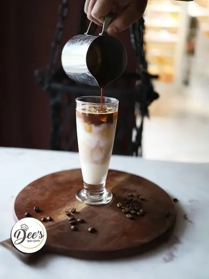 The making of a perfect iced latte. We pour a fresh shot of espresso over chilled milk and ice for a refreshing caffeine kick.