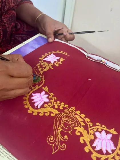 Hands-on learning in our fabric painting class, where students learn to apply traditional Tanjore motifs onto textiles.