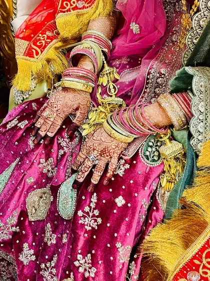The moment of "Qubool Hai". A beautiful capture of the bride's hands during the nikah ceremony, showcasing the lovely henna stain.