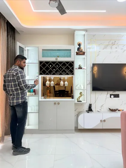 A closer look at the custom bar and crockery unit. The mirrored back and internal lighting beautifully highlight the glassware, while the dedicated wine rack and cabinets provide organized storage for all your entertaining needs.