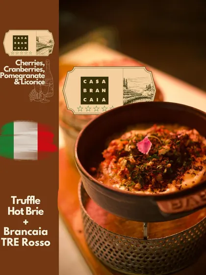 The earthy and decadent Truffle Hot Brie paired with a Brancaia TRE Rosso Toscana. The wine's cherry and licorice notes balance the richness of the brie, demonstrating our skill in creating harmonious flavor combinations.