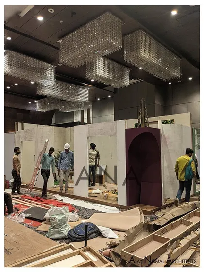 The construction of the Villandi '22 stall in progress. Here, our team works on installing the main wall structures and the signature purple arched vault, showcasing the build process before the final finishes are applied.