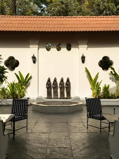 Views of the courtyard at Elgin Cafe, a space designed for pause and reflection. I used white lime-washed walls, lush tropical plants, and classic lantern-style lighting to create an intimate, serene outdoor dining experience.