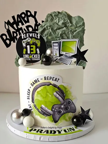 Level 13 unlocked. This gaming-themed cake is perfect for an official teenager. It features a controller, headset, and computer setup, capturing the "eat, sleep, game, repeat" lifestyle.