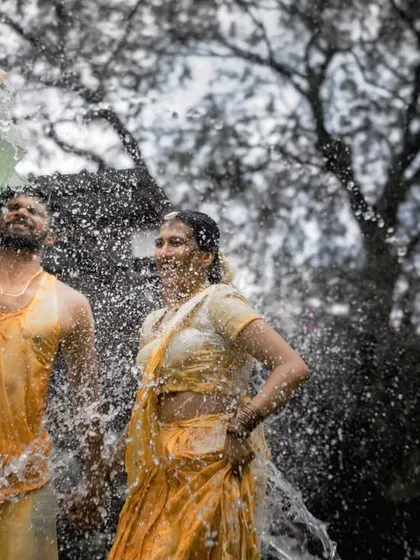 Another angle of the Haldi celebration, capturing the couple's joy as they are playfully drenched. My goal is to document the real, unscripted fun of the day.