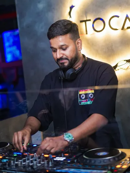 In the zone at Toca, with the club's logo glowing behind me. This shows me in my element at one of my regular residency spots.