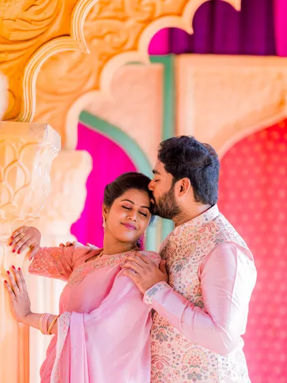 An intimate close-up from a traditional photoshoot. This tender moment, a gentle kiss on the forehead, captures the deep affection and emotion between the couple, making it a powerful portrait.