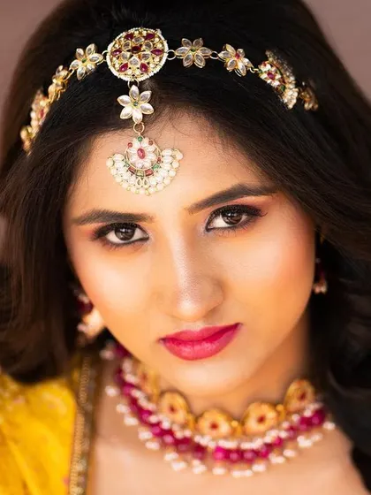 A close-up beauty shot of Priyadarshini SK, focusing on her traditional jewelry and makeup. This is ideal for showcasing detailed styling.