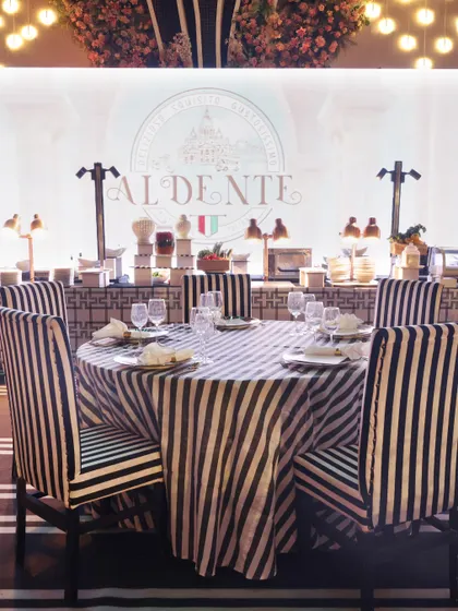 Our "Al Dente" Italian station, set against a striking black-and-white striped theme. We can tailor our station designs to match any event style, from classic elegance to modern chic.