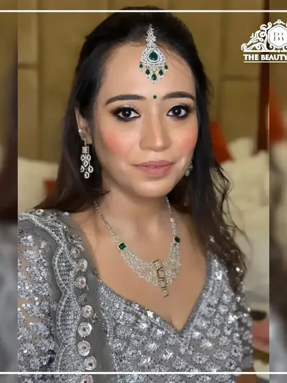 A direct, confident look from the client. The eye makeup is the star, with a beautiful blend of silver and black to create a glamorous effect.