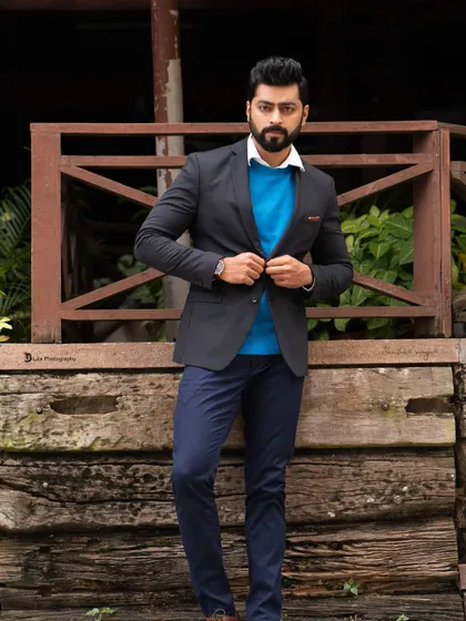 A classic pose from Tarak Ponnappa's shoot. The combination of the wooden fence and his sharp attire creates a balanced and professional look.