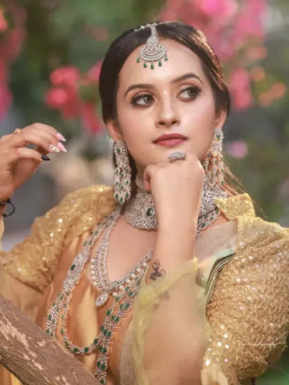 A collection of portraits featuring a model in a golden-hued traditional outfit, shot outdoors. The natural light and garden setting add a soft, ethereal quality to these elegant images.