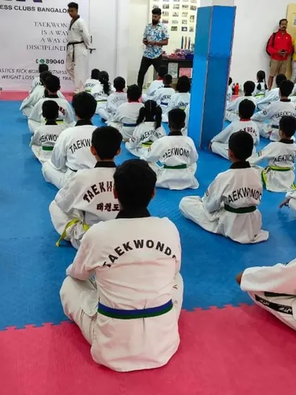 Students watch their peers perform during the belt test, a learning experience for everyone.