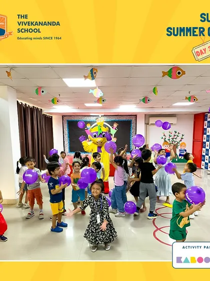 Pure joy and energy! Children dance and play with balloons as our mascot joins the party during a special activity day with The Vivekananda School.