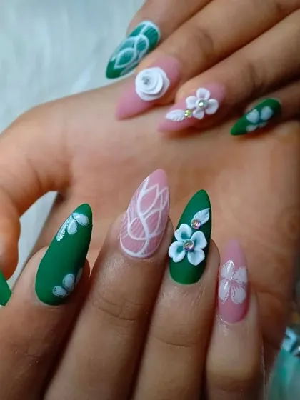 This matte-finish set combines green and pink nails with intricate white line work and beautifully sculpted 3D flowers.
