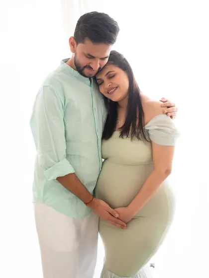A tender embrace. This light and airy photo beautifully captures the affection and closeness of the couple as they await their little one.