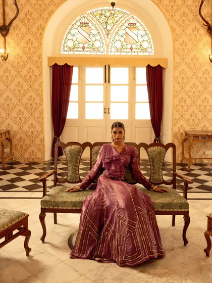 A wide, symmetrical shot that captures the grandeur of the location and the elegance of the ethnic wear. This is a perfect establishing shot for a high-end campaign.