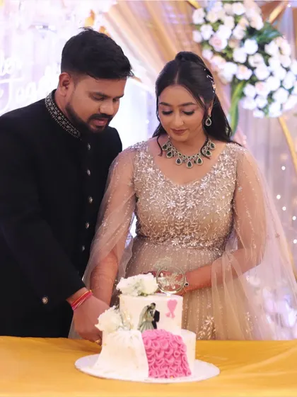 A sweet moment during the cake cutting ceremony. The bride's makeup is soft and romantic, perfect for her engagement celebration.