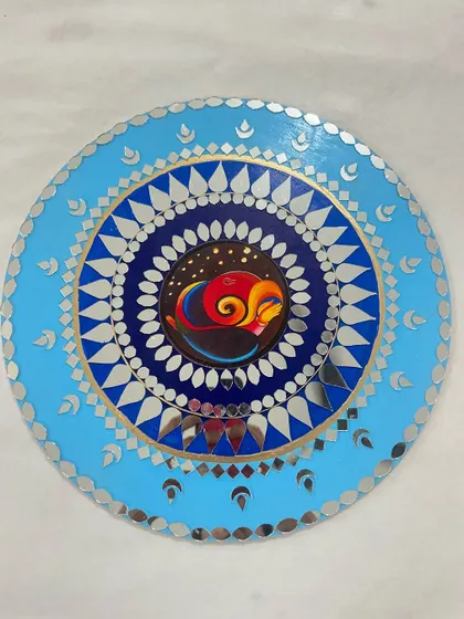 A Ganesha-themed mirror art piece, combining painting with traditional mirror work.