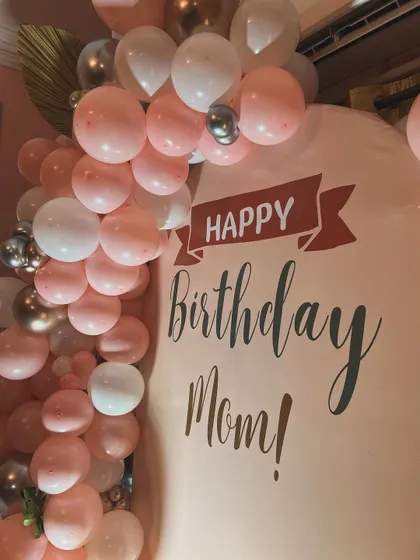 A personalized touch for a special celebration. This custom 'Happy Birthday Mom!' backdrop was the centerpiece of the 50th birthday decor we designed.