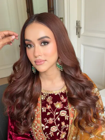 A close-up showing the soft waves in her hair and the beautifully blended makeup. This look is all about enhancing her features in a subtle and sophisticated way.