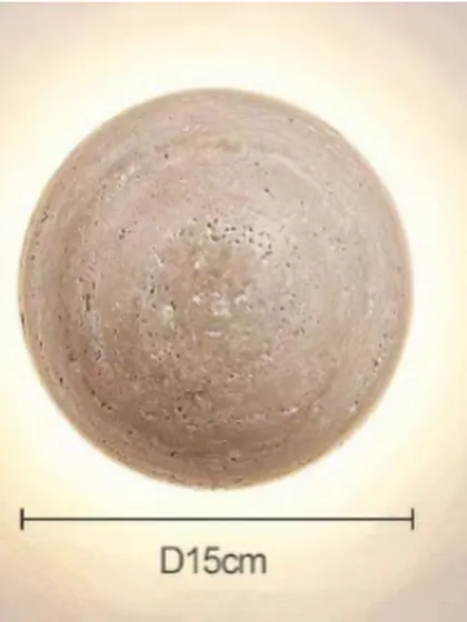A spherical wall light made from travertine stone. The 15cm diameter makes it a perfect accent light, with a warm glow that highlights the stone's texture.