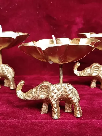 A front view of the elephant urli candle set.