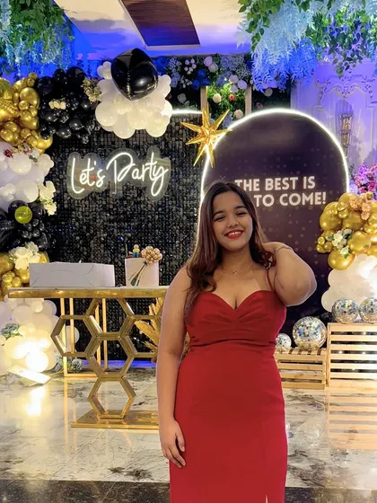 A happy guest posing in front of the retirement party decor. We love seeing everyone enjoy the photo corners we create.