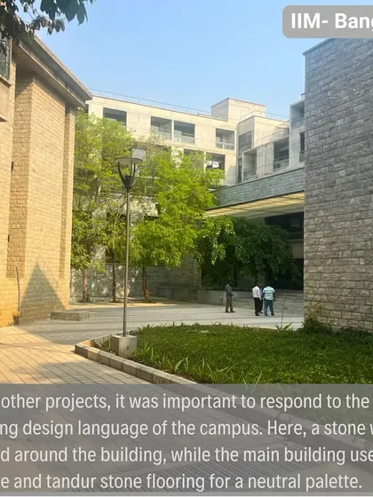 A stone wall wraps the new hostel building, a direct response to the material language of the original campus. The main structure uses concrete and Tandur stone flooring for a neutral, timeless palette.
