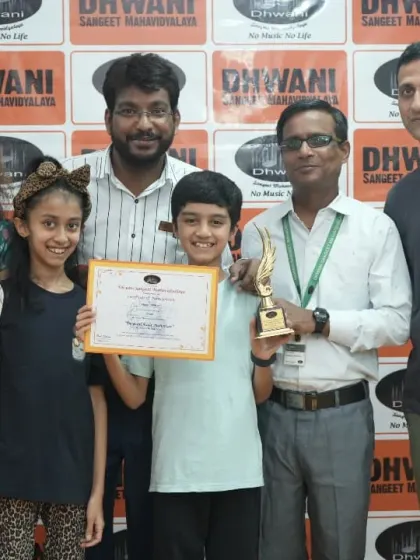 A family photo of success, with a student, his parents, and his teachers all celebrating together.