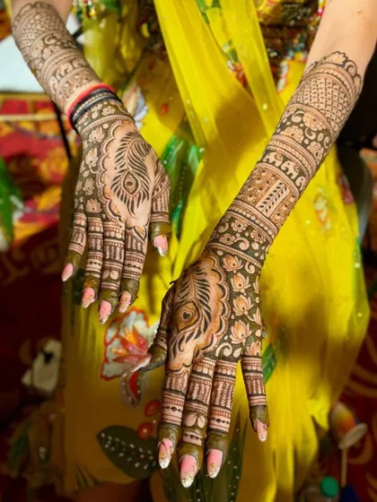 A beautiful bridal design featuring peacock feather motifs on the palms.