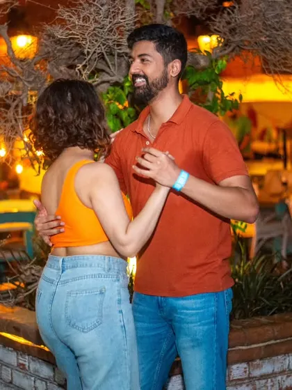 A close and connected moment under the warm tree lights. The ambiance is perfect for a Sunday social.