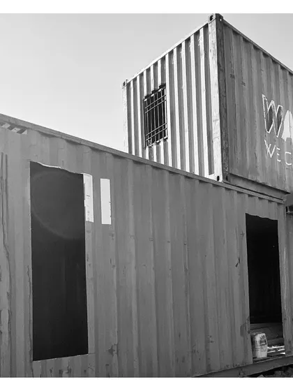 The initial cuts for windows and doors are made in the container walls. This is where the transformation from a sealed box to a habitable space truly starts.