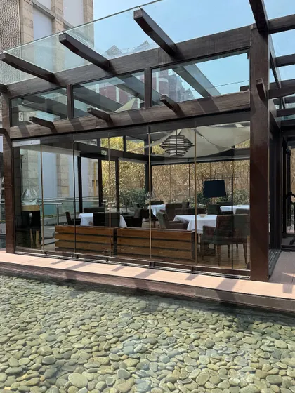 Our New Delhi restaurant is a sanctuary of light and silence. The glass-enclosed dining space is surrounded by a tranquil water feature, creating a serene backdrop for a memorable meal.